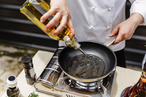 Chef Preparing Olive Oil in a Pan for Making Rosemary Oil.