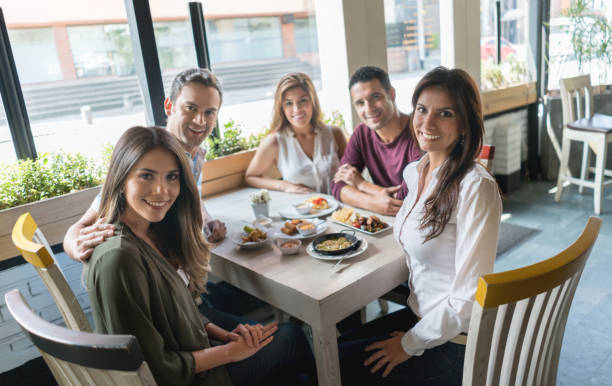 istock Group of friends eating at a restaurant 646624080