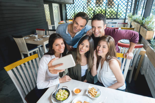 istock Friends talking a selfie at a restaurant 646624180