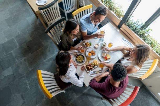 istock Happy friends eating at a restaurant 646624192