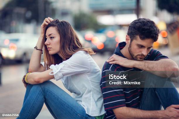 Sad Couple Leaning On Stock Photo - Download Image Now - Sadness, Women, Couple - Relationship