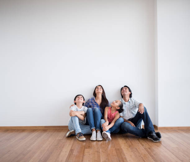 istock Family sitting at an empty room thinking about interior design 646688500