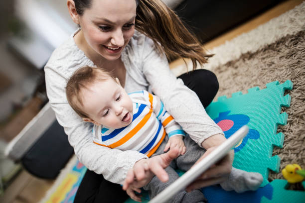 istock Mother and baby playing with digital tablet 646699566