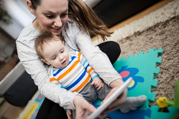 istock Mother and baby playing with digital tablet 646699868