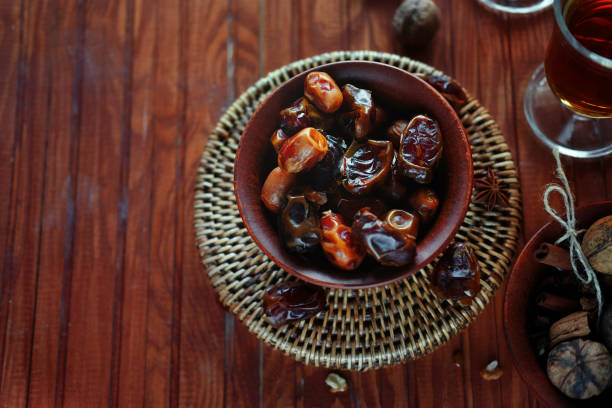 Close up date fruits (medjool) on a silver traditional plate on wood background