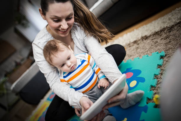 istock Mother and baby playing with digital tablet 646702184