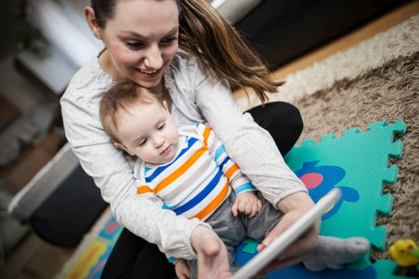 istock Mother and baby playing with digital tablet 646702188