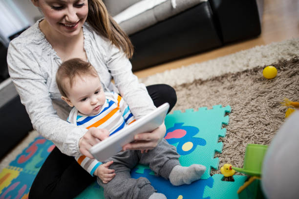 istock Mother and baby playing with digital tablet 646703148