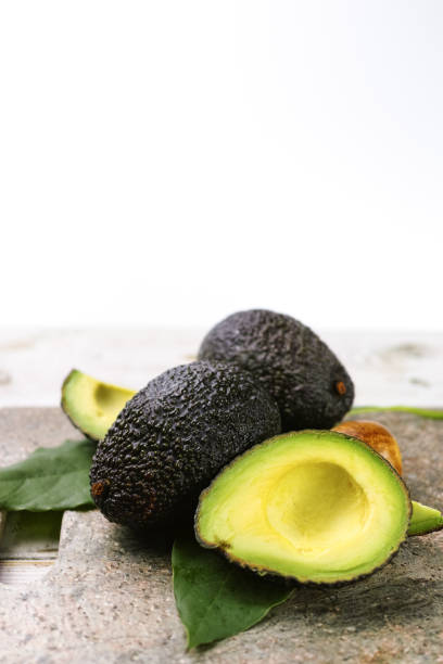 istock Green ripe avocado with leaves close up 646706454