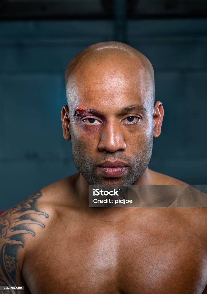 Portret of wounded free fighter after match wounded free fighter after fighting in boxing gym Healthcare And Medicine Stock Photo