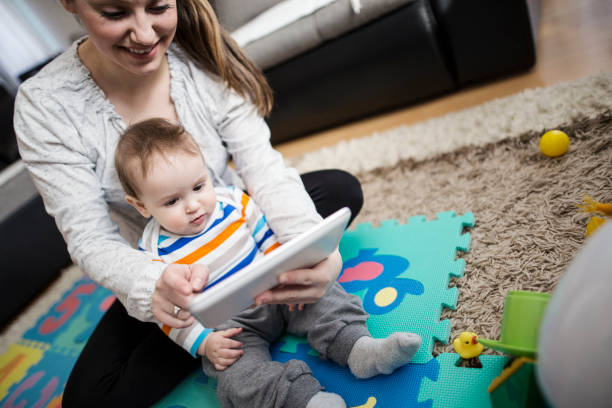 istock Mother and baby playing with digital tablet 646706672