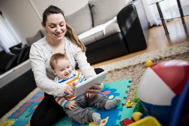 istock Mother and baby playing with digital tablet 646707210