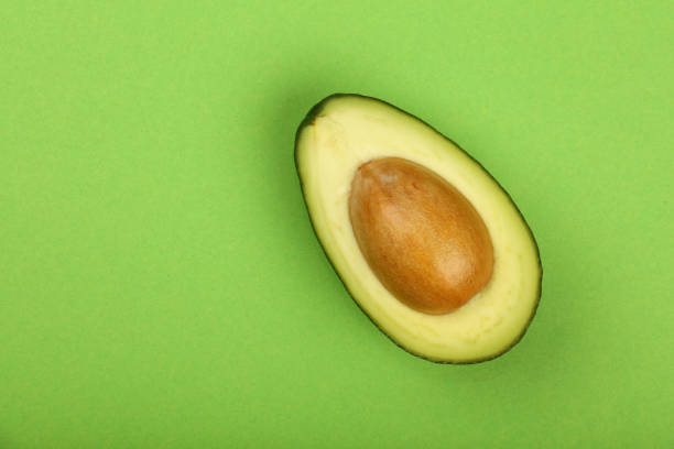 istock Fresh ripe avocado on green paper 646713936