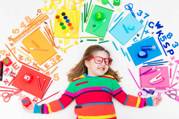 istock Child with school and drawing supplies. Student with book. 646720340