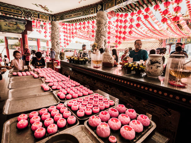 People praying in Thean Hou temple in Kuala Lumpur Malaysia during the Chinese New Year celebration. This is a syncretic temple with elements of Taoism Buddhism and Confucianism although it is dedicated to the chinese Sea Goddess Mazu.