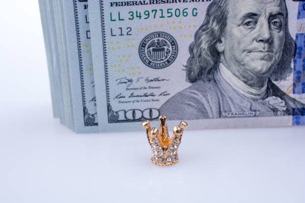 istock American 100 dollar banknotes  and a  crown 646723022