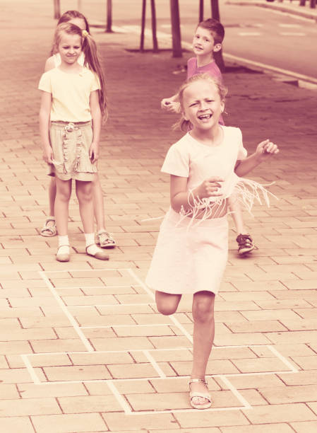istock children skipping hopscotch 646726650