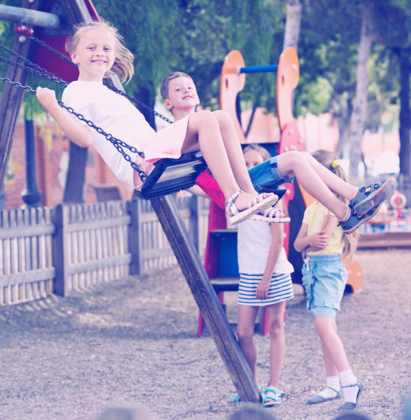 istock Girl sit in moving swing 646726656