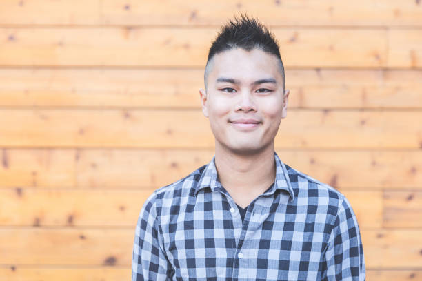 istock Asian man portrait against wood background 646730384