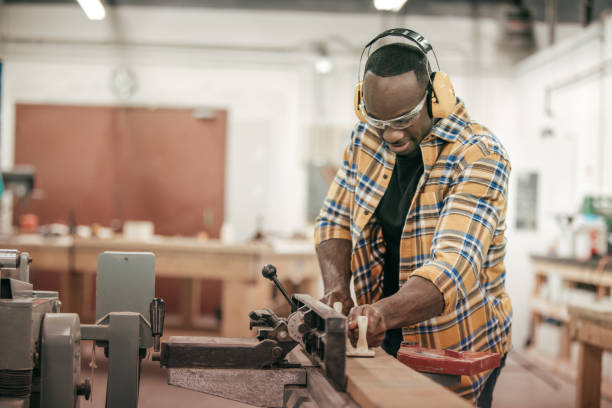 istock Male carpenter working with power tools in his wood shop 646741744