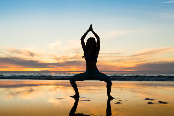 istock Women Silhouette Doing Yoga On The Ocean 646753890