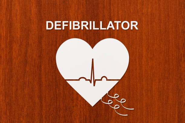 Heart shape with echocardiogram and DEFIBRILLATOR text. Medical cardiology concept