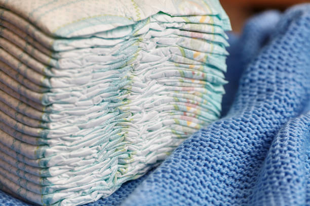 istock Stack of diapers or nappies on knitted blanket 646787166