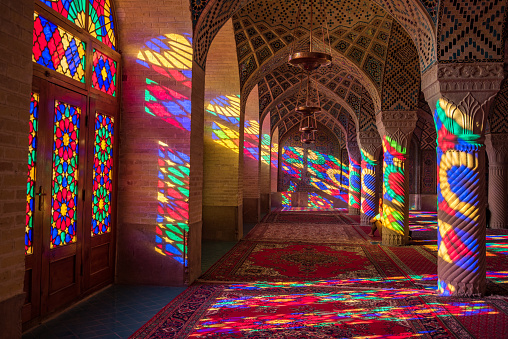 Colorful light through stained glass window inside Nasir Al-Mulk Mosque (Pink Mosque), a traditional mosque in Shiraz, Iran