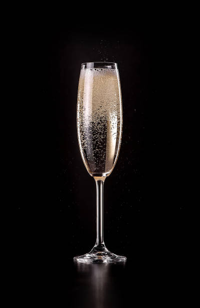 glass of sparkling champagne on black background glass of sparkling champagne with bubbles on black background rose champagne stock pictures, royalty-free photos & images