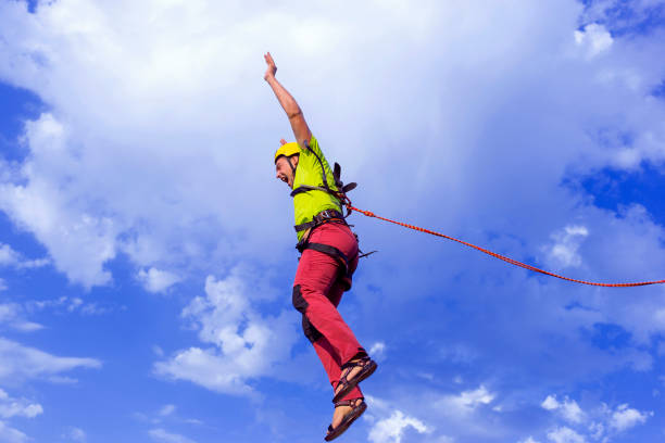 istock Jump rope from a high rock in the mountains. 646801644