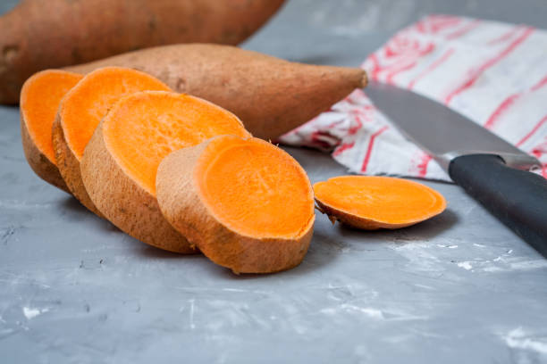 istock Raw sliced and whole sweet potatoes 646804108