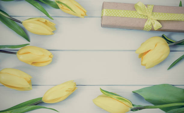 istock Greeting Card with yellow tulips and gift present 646804264