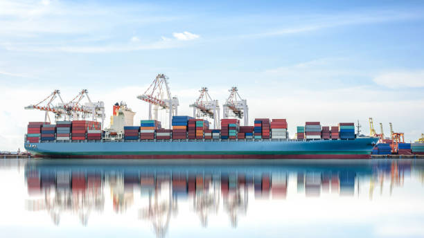 istock International Container Cargo ship with working crane bridge in seaport 646804908