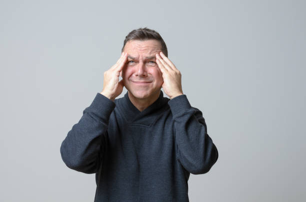 istock Frustrated man with his hands to his temples 646808068