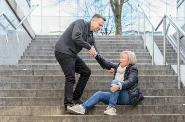 Photo of Man helping woman to get up