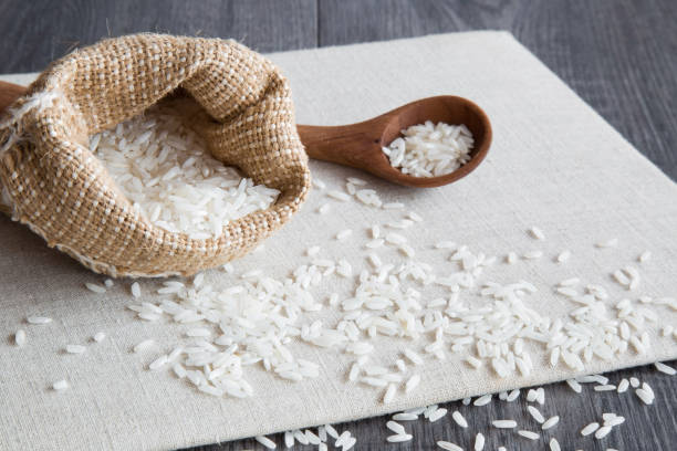 istock Rice in the burlap bag on the cloth plate. 646817490