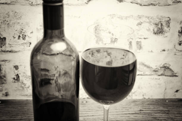 Bottle of red wine with glass ready to be poured