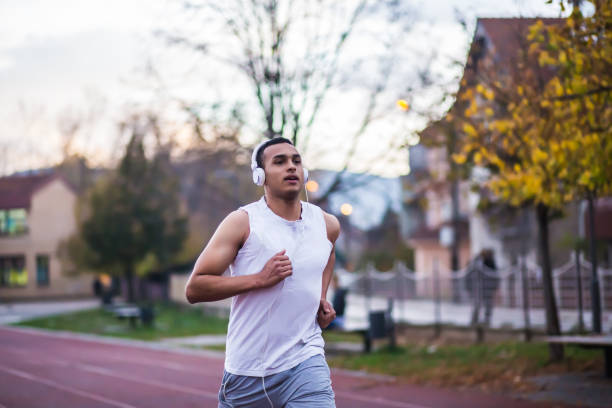 istock Young man with headphones running in the morning 646824072