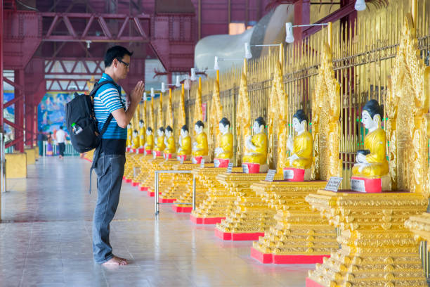 Man is praying Buddha Statue in pagoda