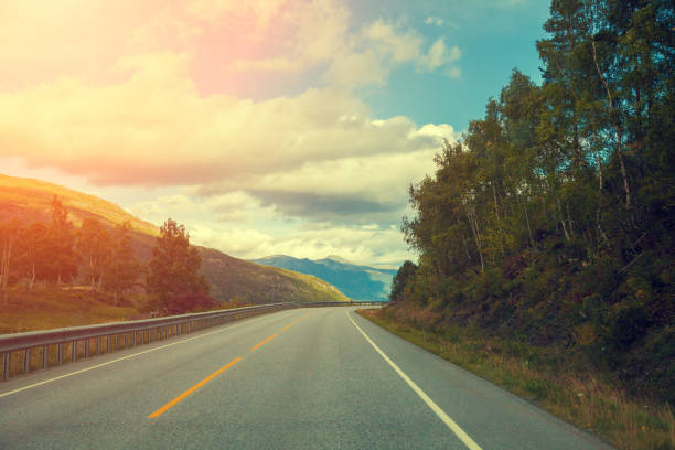 istock Mountain road at sunset with cloudy sky 646839702