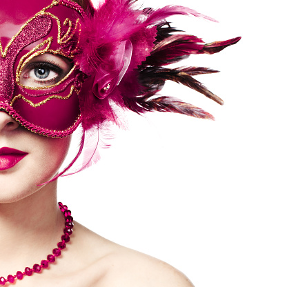 Beautiful young woman in mysterious golden Venetian mask. Fashion photo