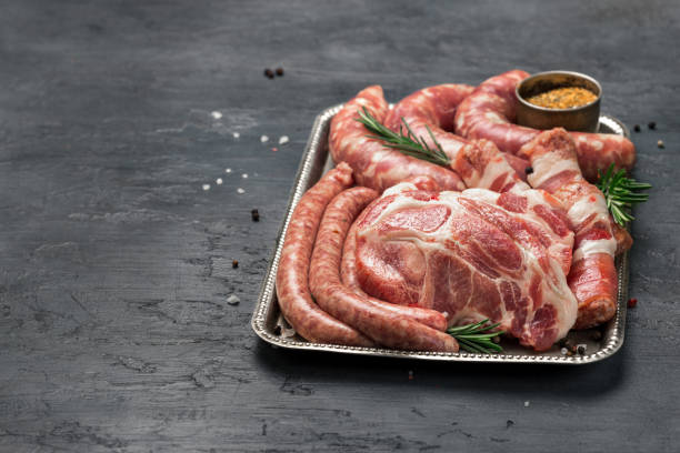 istock Set of different meat products on iron tray on a dark surface 646844502