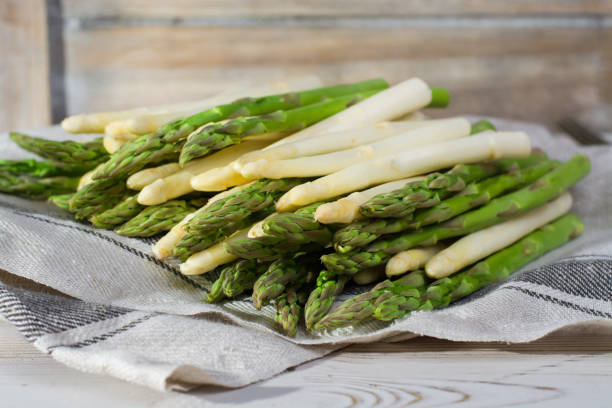istock Spring season - fresh white and green asparagus on linen napkin 646845046