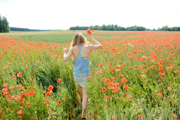 istock woman in poppy field 646851014