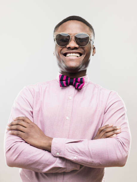 Cheerful young african man standing with his arms crossed
