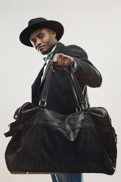 Stylish young african man with handbag