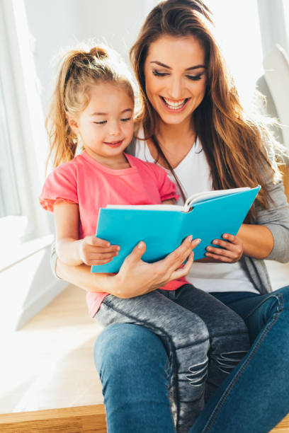 istock Mother and daughter reading a book 646852430