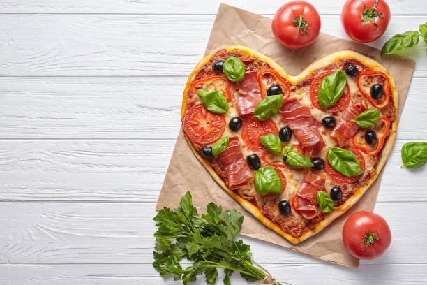 istock Heart shaped pizza love concept Valentine's Day symbol romantic dinner 646853500