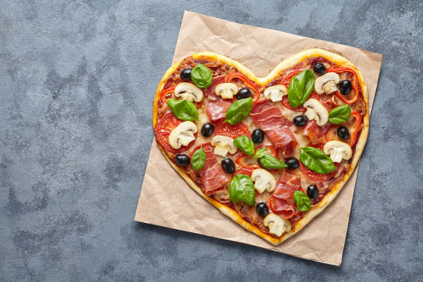 istock Heart shaped pizza love concept Valentine's Day romantic homemade dinner 646856362