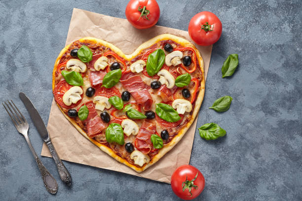 istock Heart shaped pizza love concept Valentine's Day flat lay romantic restaurant dinner 646856480